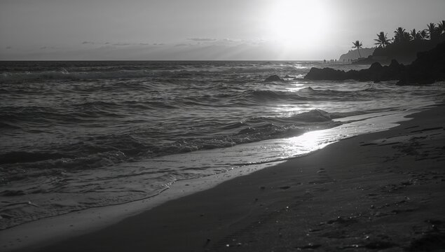 Sunset over the ocean waves on a monochrome shoreline