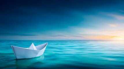 Obraz premium Paper boat floats on ocean at tranquil sunset small craft navigates vast sea under colorful evening sky
