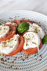 Caprese salad plate showing fresh mozzarella and tomato