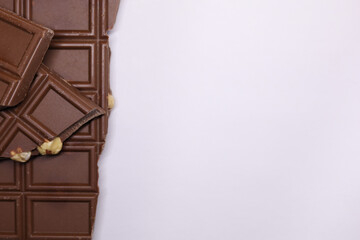 Milk Chocolate with Nuts on White Background – Gourmet Snack Composition