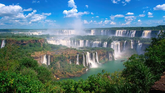 Scenic outlook of a waterfall after intense rainfall with maximum water flow on a bright day