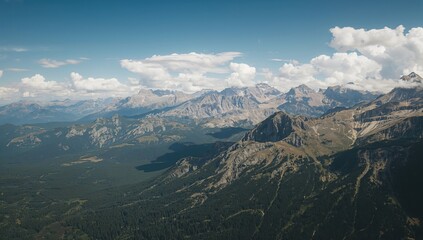 Obraz premium Aerial view of mountains under a clear sky, showcasing seasonal change