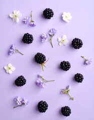 Blackberries and Delicate Flowers on Lavender Background - A Fresh and Natural Composition.