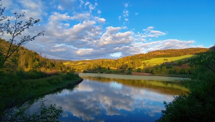 Fototapeta premium Crisp reflections of clouds on a reservoir surface, emphasizing natural beauty and seasonal change