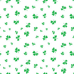 Green white shamrocks seamless vector pattern background. Tossed three leaf clover on white backdrop. Irish lucky charm motifs. Scattered St. Patricks day symbols for celebration background.