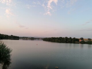 Still Lake Water at Sunset or Twilight with Pastel Sky Colors and Horizon