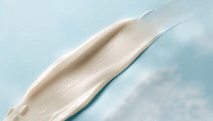 Cream texture smears on a blue surface, suitable for editorial design
