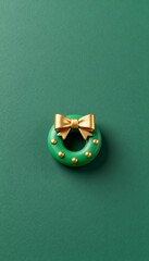 Cute tiny 3D wreath toy with gold bow minimal Christmas decoration in green and gold color palette