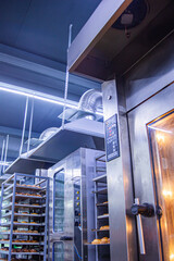 Stainless steel exhaust hood with grease trap close-up in a large industrial kitchen in the...
