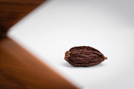 Dried tamarind fruit displayed on a white background