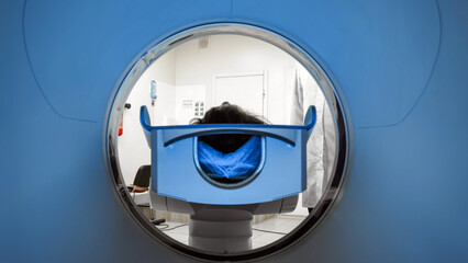 CT scanner in a medical facility, showcasing a patient positioned for examination, with a focus on...