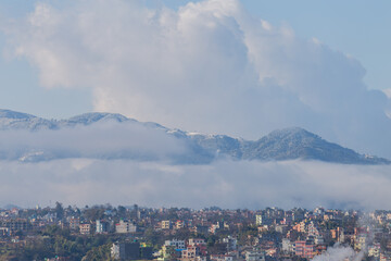 Obraz premium Snowfall in Kathmandu City with Hills Covered in Snow