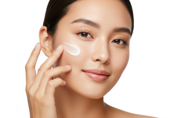 Beautiful asian woman applying cream on her face isolated on transparent background young woman with perfect skin and natural makeup applying moisturizer