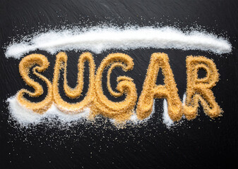 Sugar written in brown sugar granules on black background