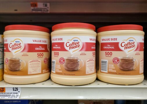 Delaware, U.S - Oct 29, 2025 - Three value-size containers of Nestle Coffee-mate The Original non-dairy creamer displayed side-by-side on a supermarket shelf.