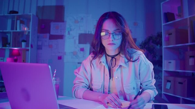Design Thinking, Creative Workflow, Visual Planning. Woman Sketches in Front of Laptop, Surrounded by Drafts on the Wall. A Moment of Concentration in a Personal Studio of Ideas and Structure