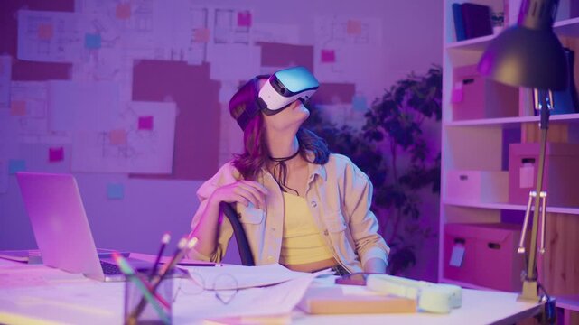 Mixed Reality, Immersive Tech, Gen Z Future. Girl Sits in Neon-Lit Room Wearing VR or AR Glasses, Interacting with Digital Space. Personal Moment in a Visually Intense Virtual World