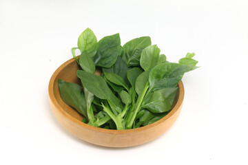 Basella alba - leaf vegetable in wooden bowl on white background