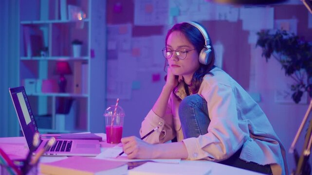 Creative Industries, Future Professions, Digital Youth. Teen Girl in Neon Room Works on Homework or Creative Project. Focused and Inspired by Design, Content, or Coding in Personal Space
