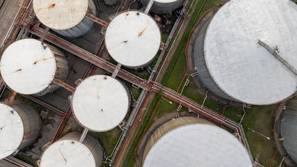 Aerial top view of oil and gas petrochemical storage tank and pipeline steel, Oil and gas transportation system pipeline steel at oil and gas refinery industry chemical plant, Pipeline oil and gas.