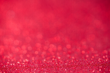 Sparkling red‑pink glitter bokeh background with shallow depth and copy space, perfect for festive banners, Christmas or Valentine cards. Photo