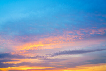 Beautiful sunset or sunrise sky with vibrant clouds changing from purple to orange is perfect for an abstract or nature background.