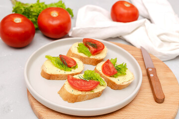 Bruschetta sandwich bread toast with cheese ricotta,tomatoes. healthy vegetarian food,Italian cuisine appetizer,basil greenery on cutting board. top view flat lay.