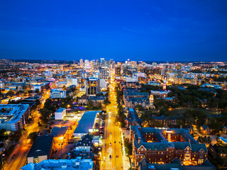 Naklejka premium Nashville skyline at night, looking down Broadway, with Vanderbilt in foreground.