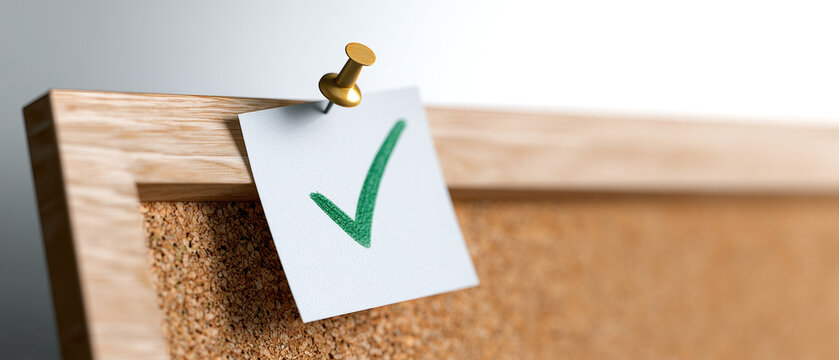 A green check mark on a white paper pinned to a corkboard with a golden pushpin