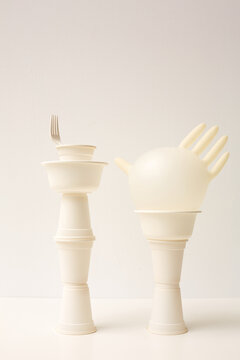 Two white towers made out from plastic dishes and latex glove art object