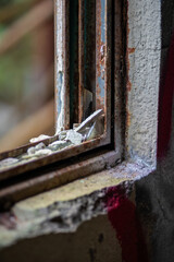 Extreme Decay: Layers of Rust and Flaking Concrete on an Abandoned Window Frame