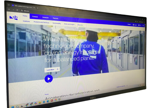 Schlumberger (SLB) logo and web page on a internet browser & dell monitor