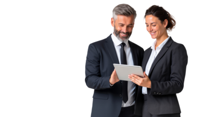 Two smiling business professionals, collaborating and reviewing content on a digital tablet, symbolizing teamwork and modern business