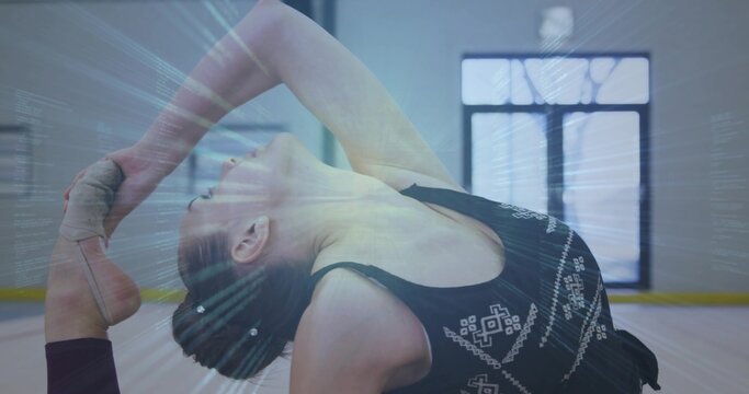 Teenage dancer performing backbend in dance studio with taped foot, parquet floor and grid window - Powered by Adobe