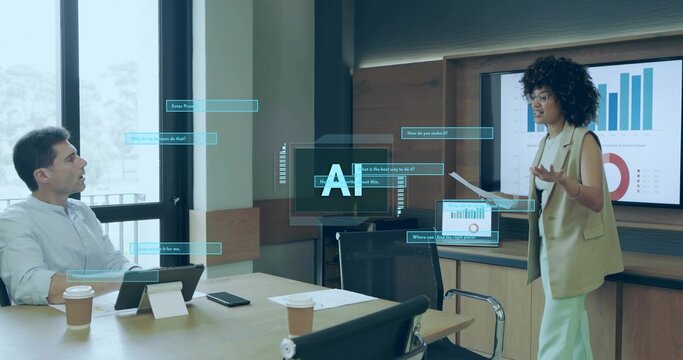 Presenting female wearing blazer holding printed charts at office table with tablet, holographic UI