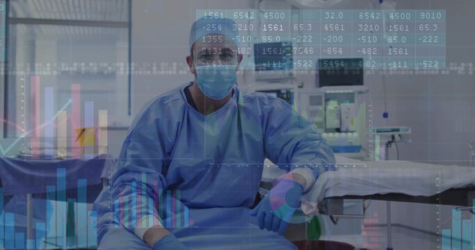 Sitting surgeon wearing blue scrubs mask at operating table in OR suite with trolley, data overlays