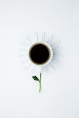 Cup of coffee with a flower on a white background