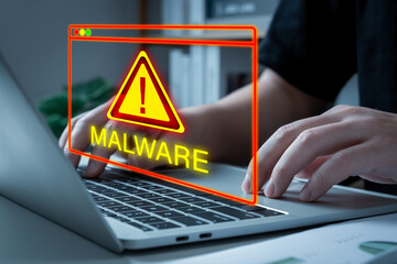 people working on laptop computer with malware attack warning graphic icon, online threat detection, virus protection software, cybersecurity, business finance, internet network technology concept