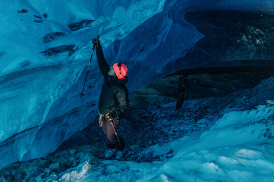 A group of skiers explore the large ice caves in the Northern Rockies of British Columbia, Canada.