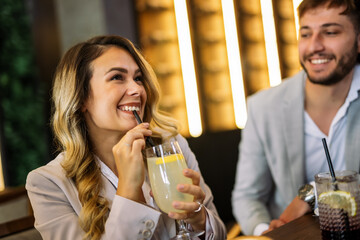 Friends enjoying drinks at fancy restaurant