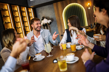 Friends enjoying drinks at fancy restaurant
