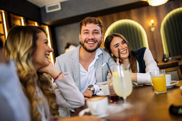 Couple hugging at restaurant with friends