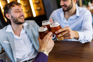 Three men cheering with beer