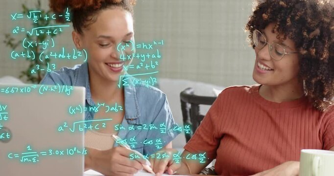 Two women sitting at table reviewing charts with formulas emerging across laptop aiding education