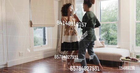 two women friends entering room with flutes dancing with floating data bonding in tech demo