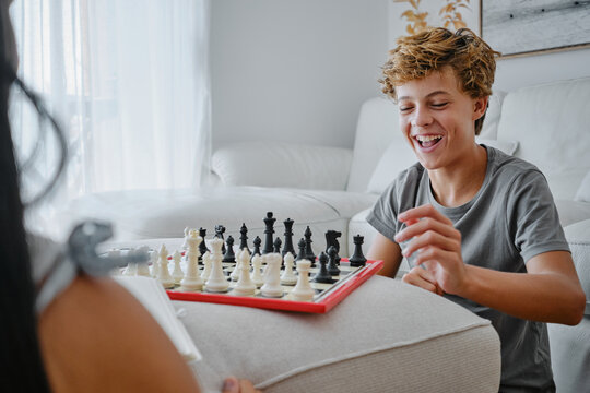 Teenager enjoying a chess game at home