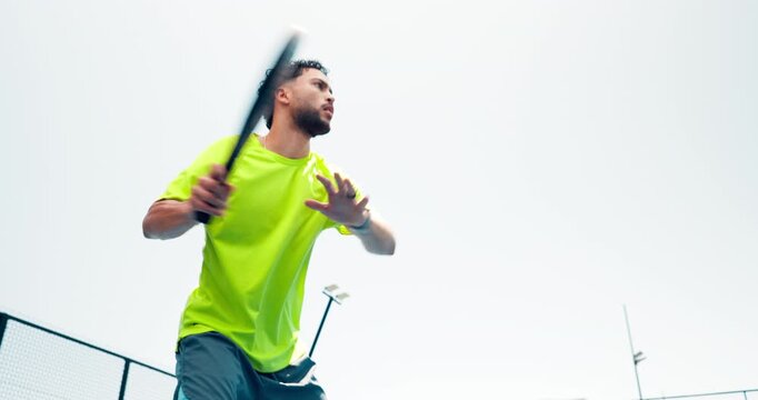 Fitness, serious and man with paddle on tennis court for serving with practice, match or workout. Sports, athlete and male person playing game with racket for exercise, training or hobby from below.