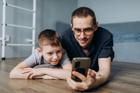 Father and son enjoying quality time with technology