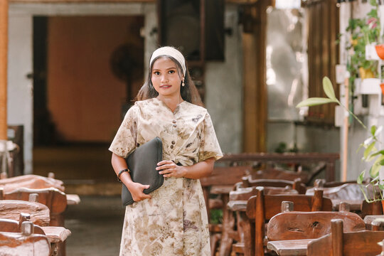 Muslim woman in eco-print dress showcasing sustainable fashion