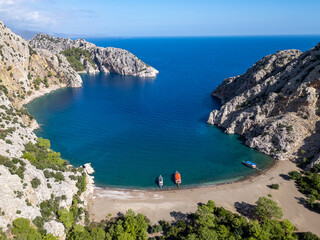 Kumluca bay with boats anchoring in turquoise water, Antalya Turkiye